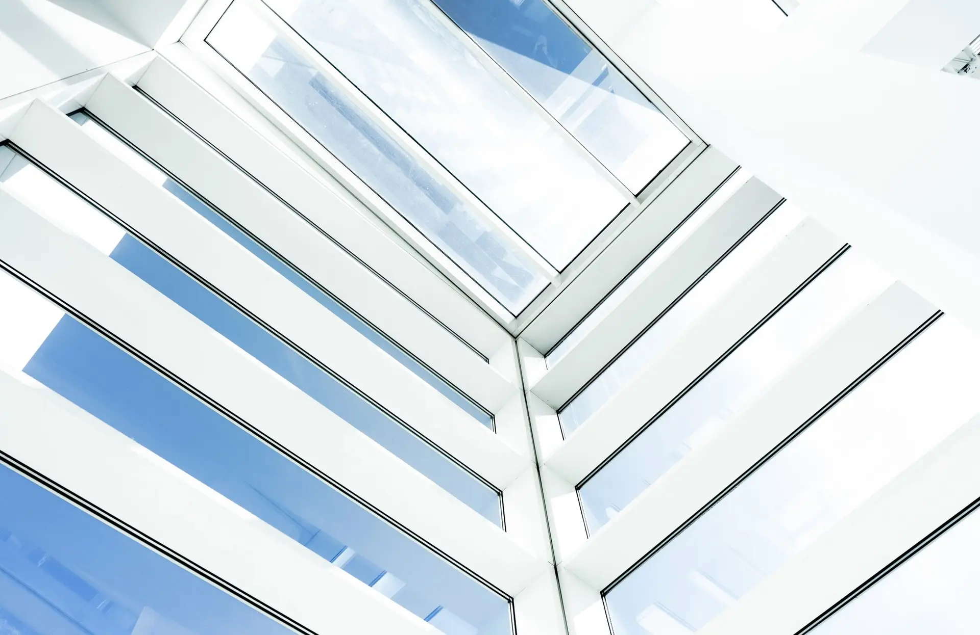 A low angle shot of an inside of a modern building with rectangular glass windows